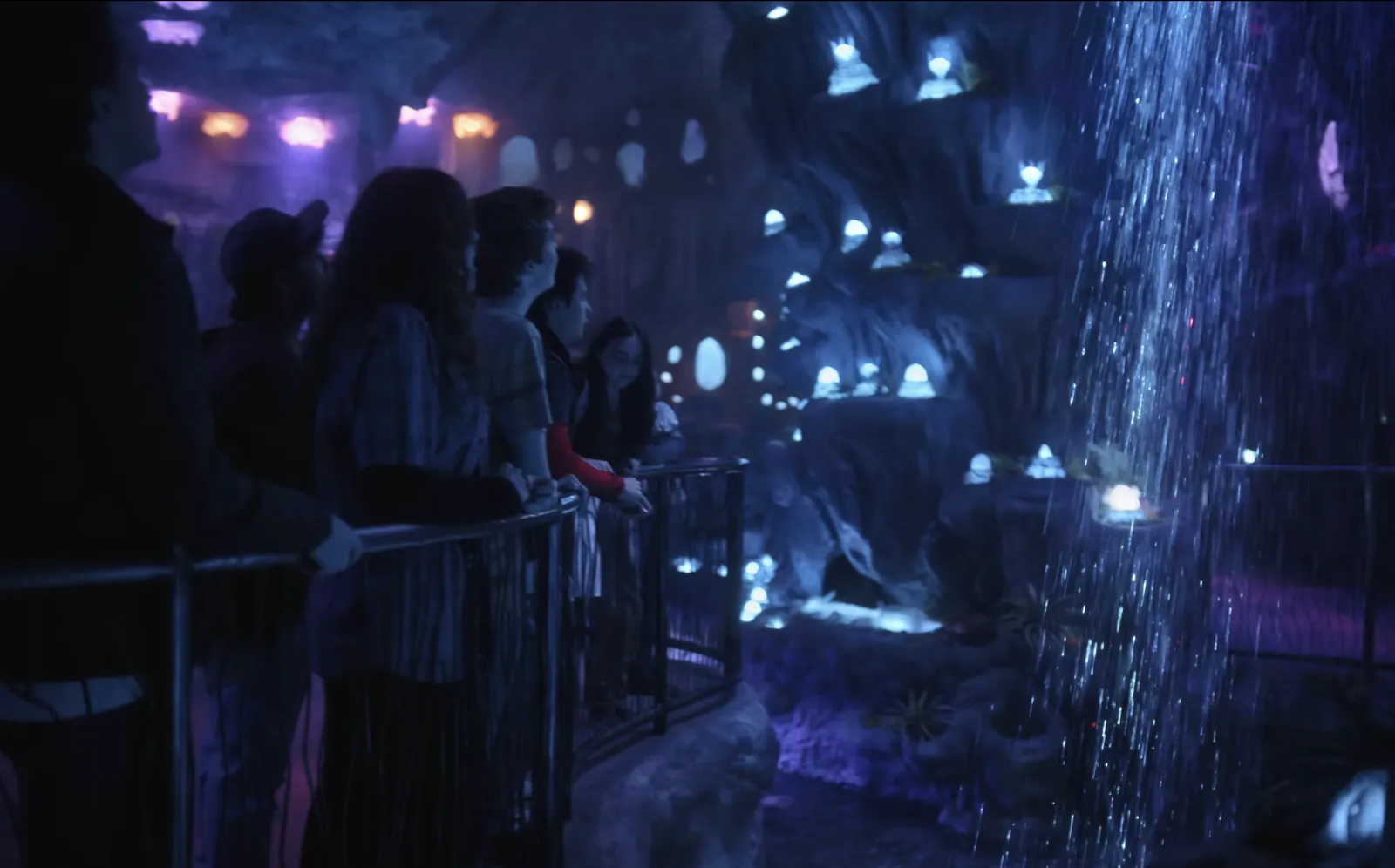 A crowd dancing to a robot DJ with lighting effects